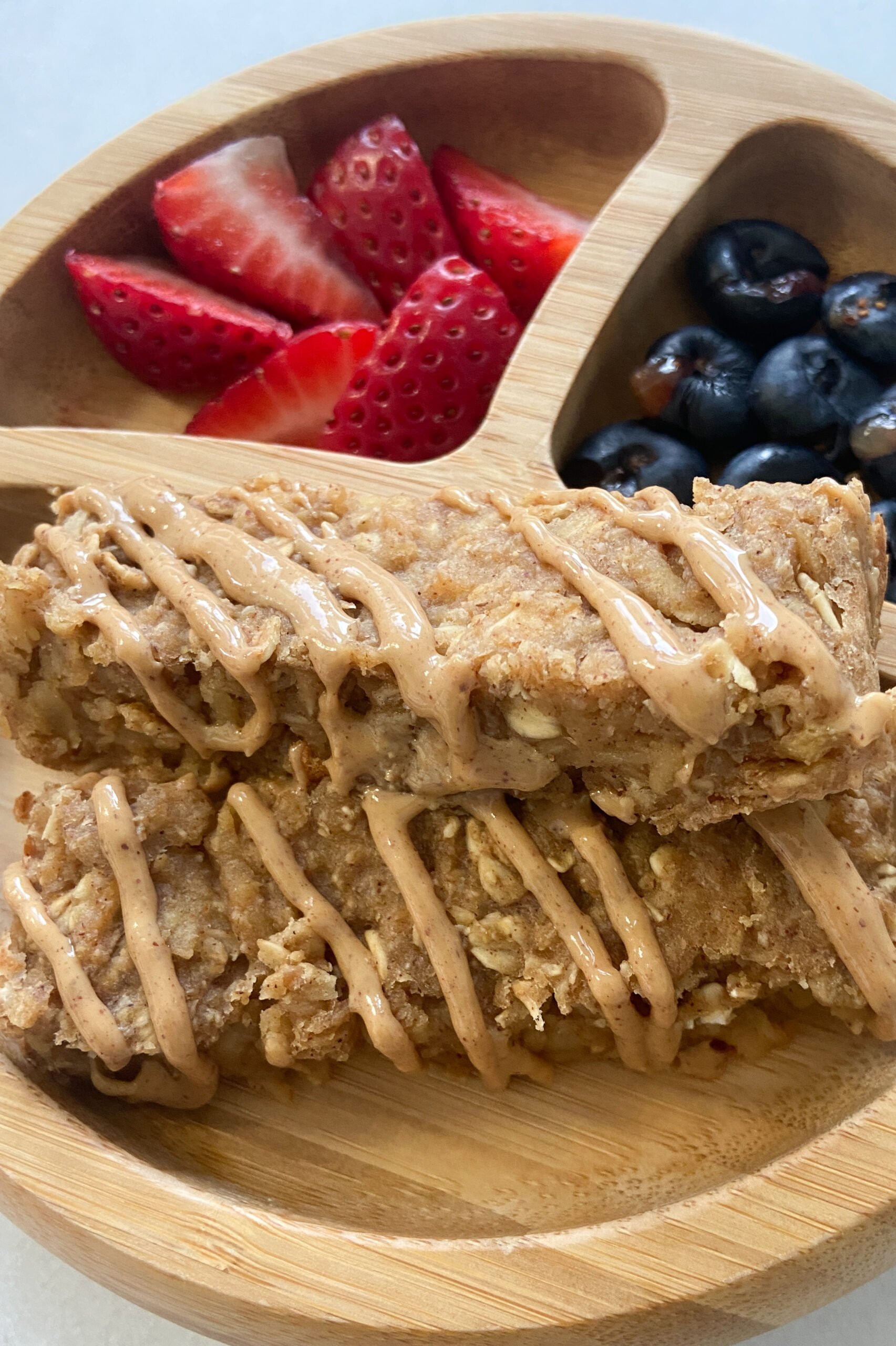 Healthy apple oatmeal bars served with berries