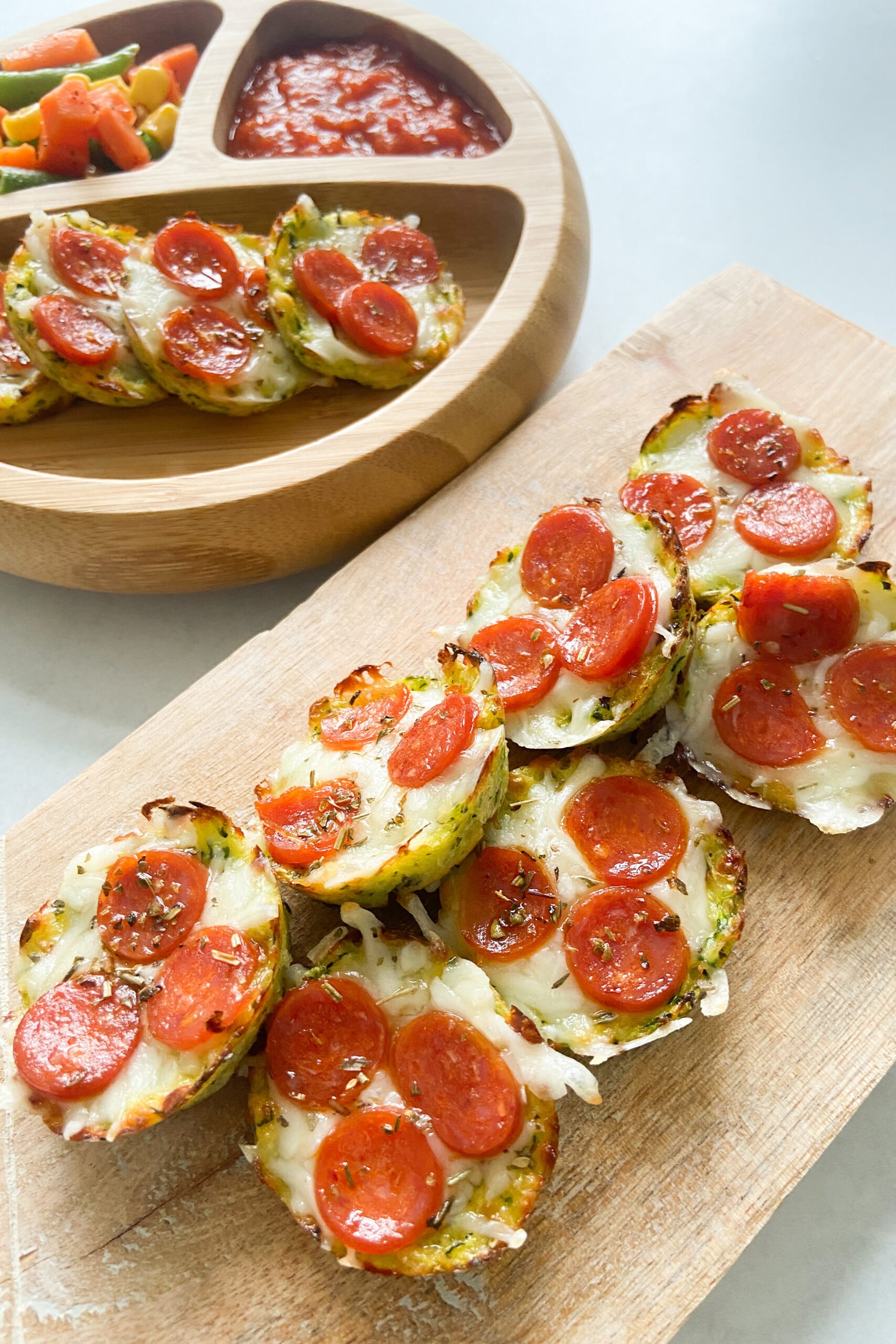 Mini zucchini pizza bites served with mixed veggies and marinara sauce