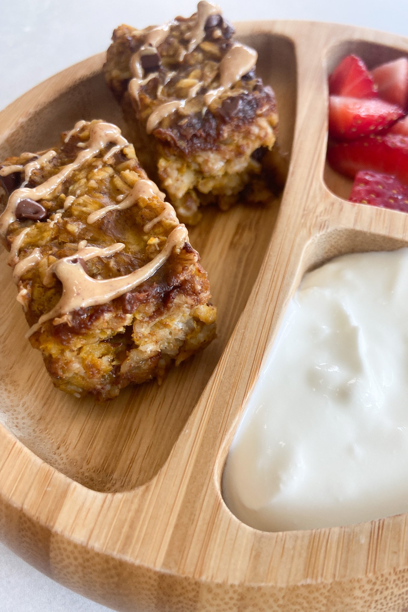 Pumpkin oatmeal bars served with berries and yogurt.