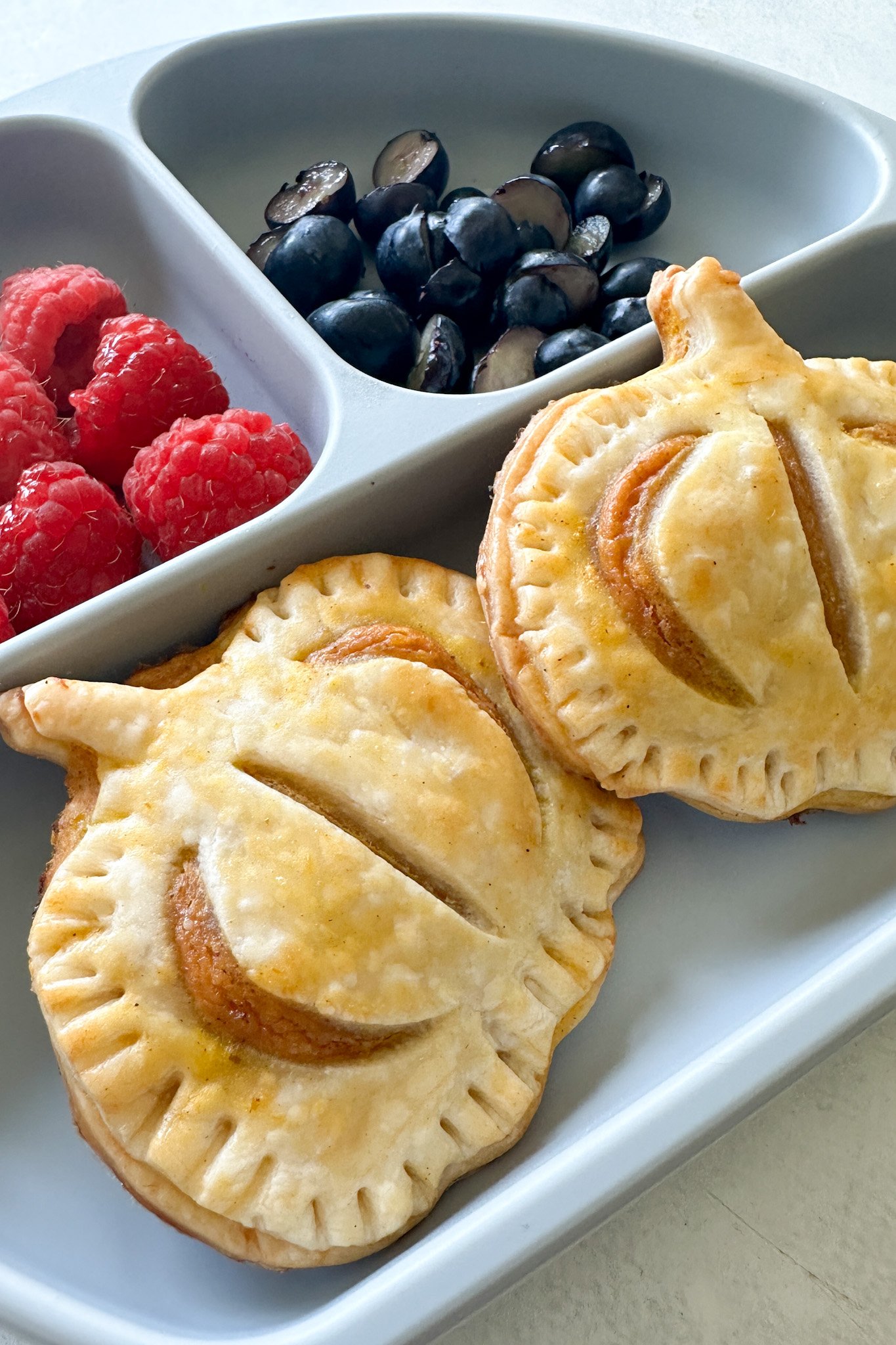 Pumpkin hand pies served with fruits.