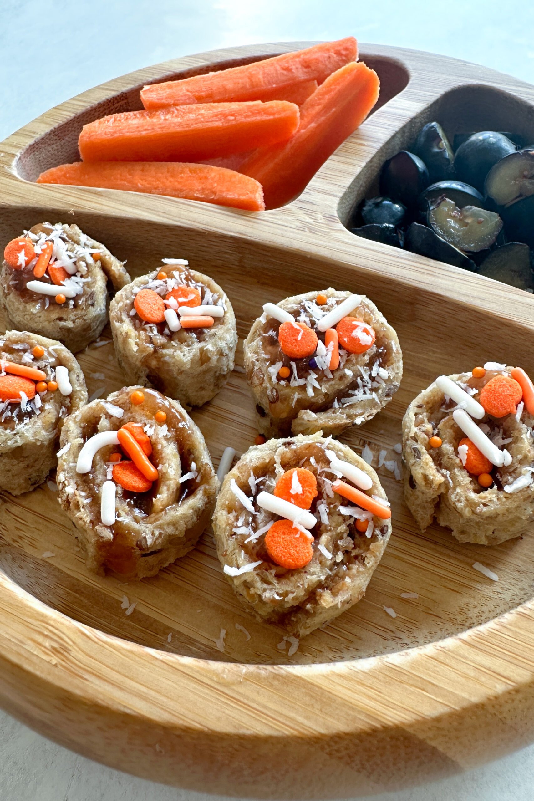 Peanut butter and jelly roll ups with orange and white sprinkles.