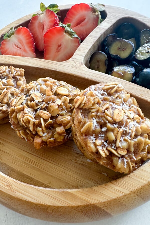 Pumpkin apple oatmeal muffins served with berries.