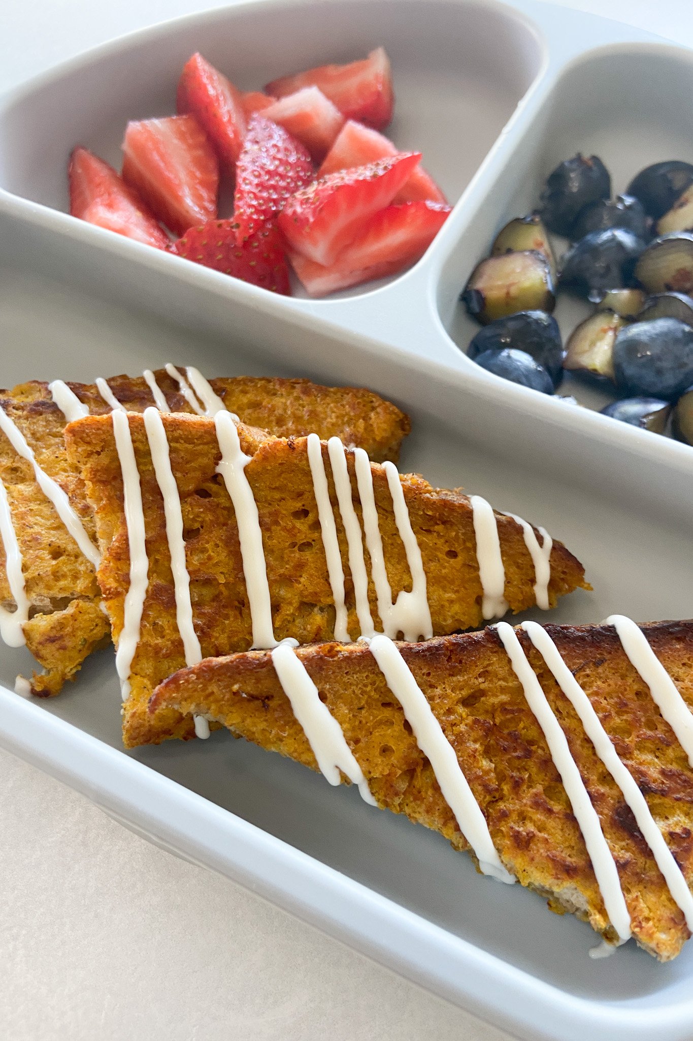Pumpkin spiced french toast served with fruits.