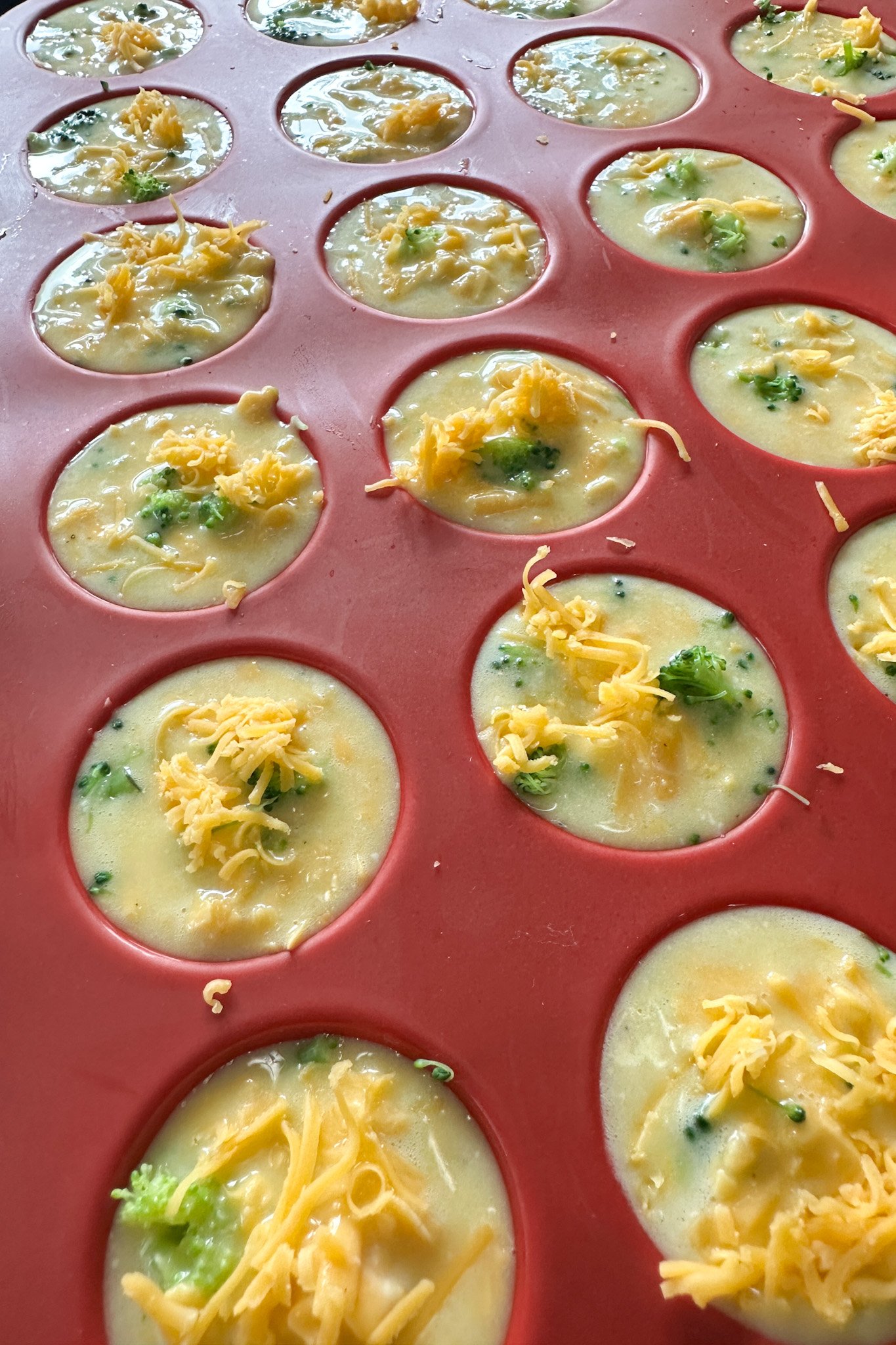 Broccoli egg bites ready to bake.