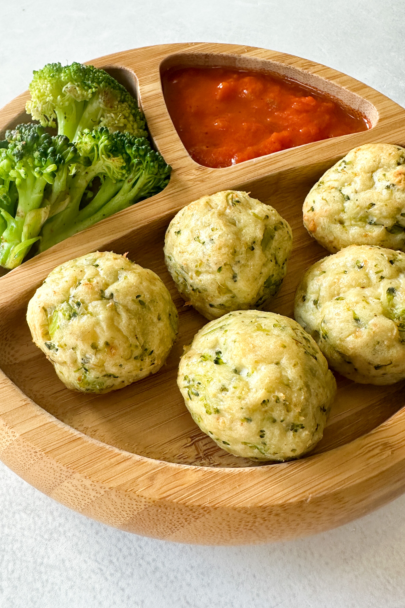 Chicken and broccoli meatballs served with marinara sauce.