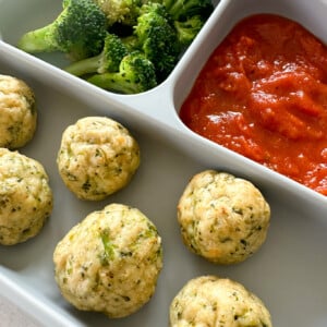 Chicken and broccoli meatballs served with marinara sauce.