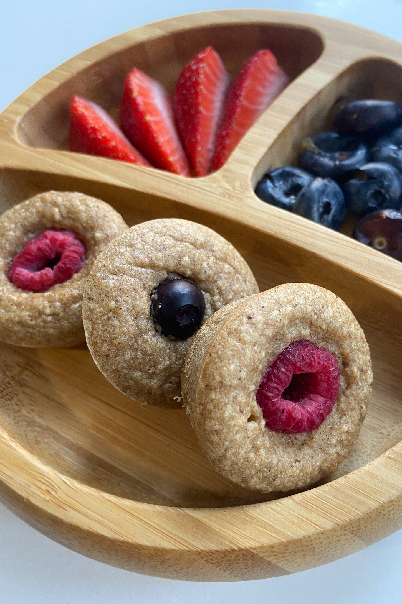 Peanut butter and jelly muffins served with berries.