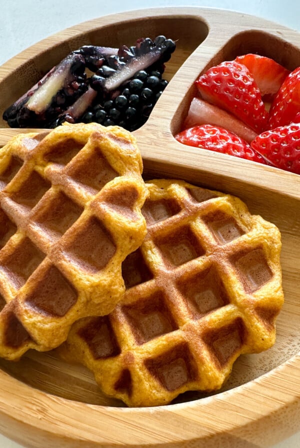 Sweet potato waffles served with strawberries and blackberries.