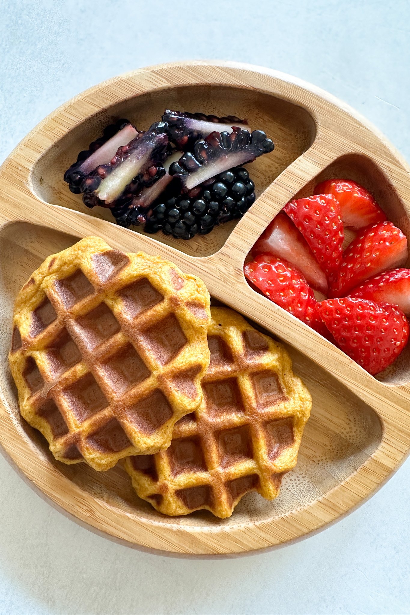 Sweet potato waffles served with strawberries and blackberries.