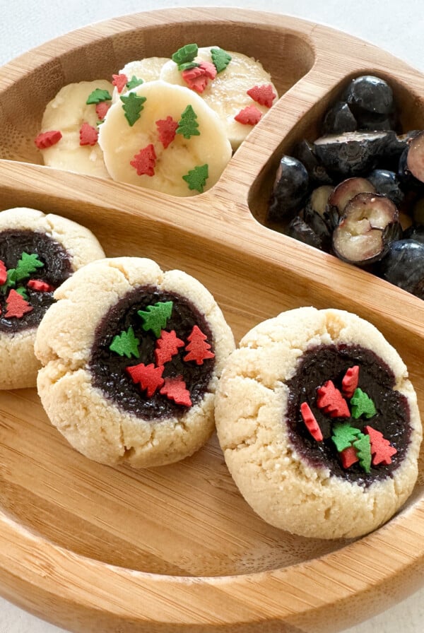 Almond flour thumbprint cookies served with fruits.