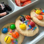 Chocolate chip almond cookies served with fruits.