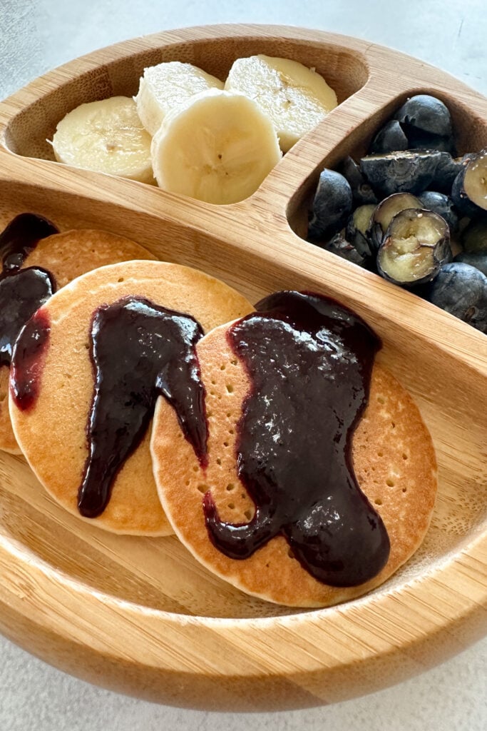 Pancakes topped with blueberry jam.