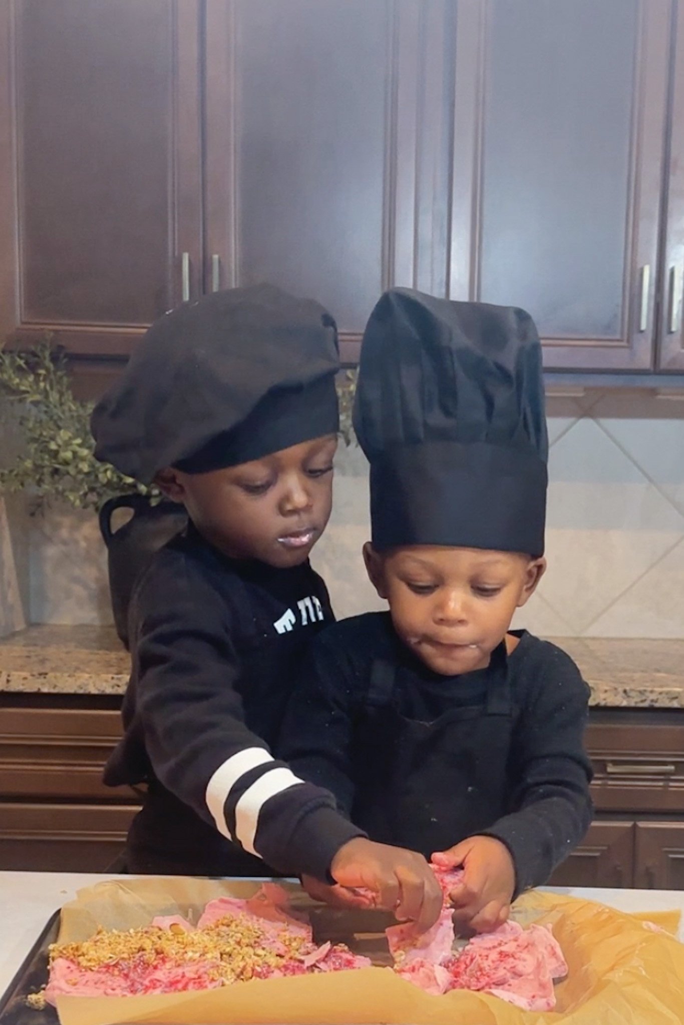 Toddlers eating yogurt bark.