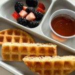 Eggless waffles served with berries and maple syrup.