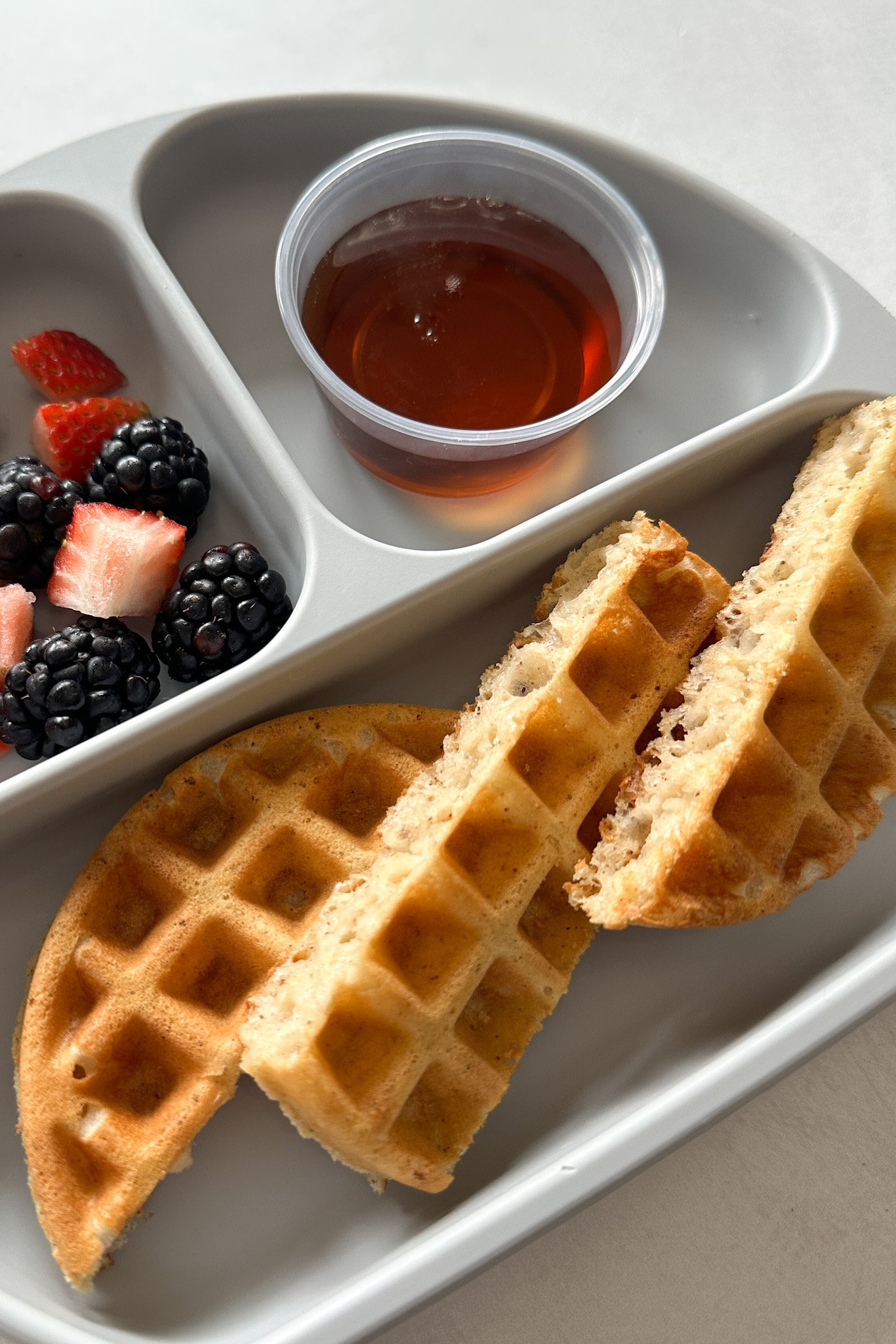 https://feedingtinybellies.com/wp-content/uploads/2023/01/Egg-free-waffles-served-with-maple-syrup.jpg