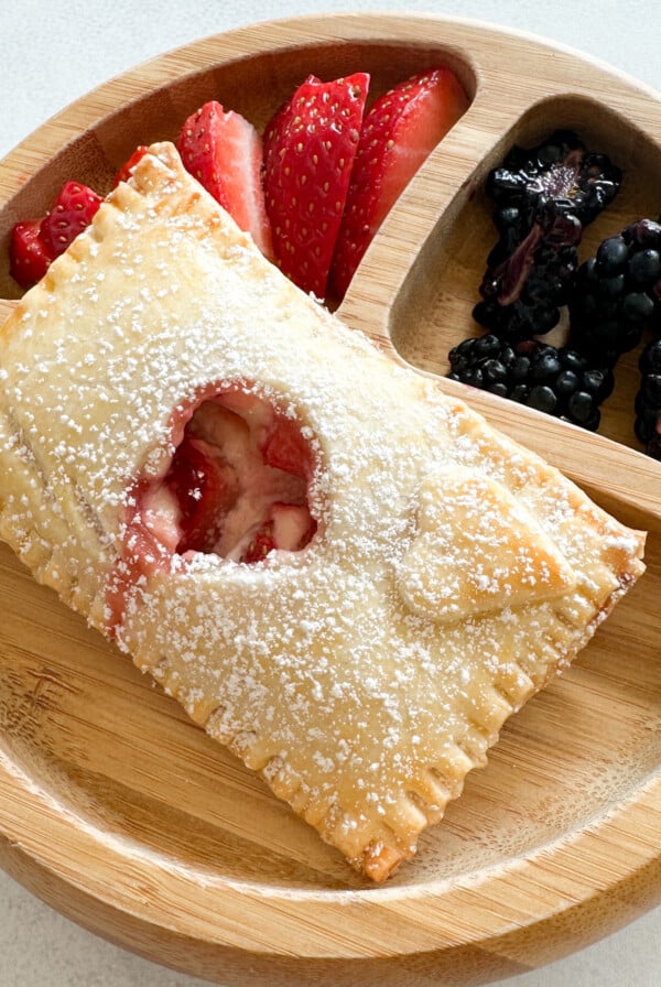 Strawberry cream cheese hand pies served with berries.