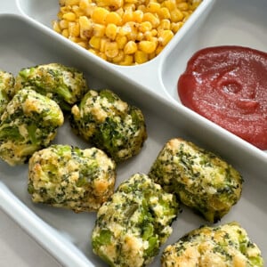 Broccoli tots served with corn and ketchup.