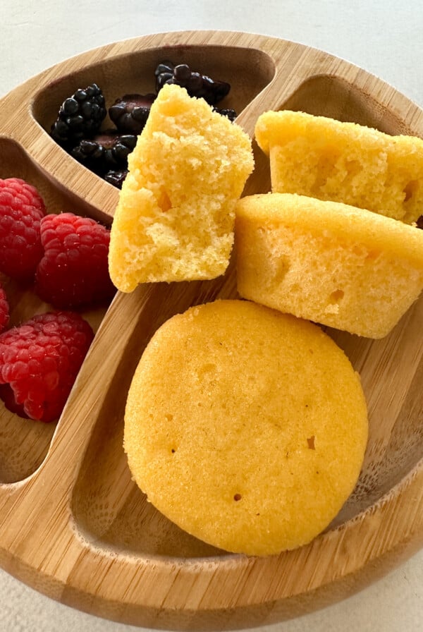 Mini cornbread muffins served with berries.
