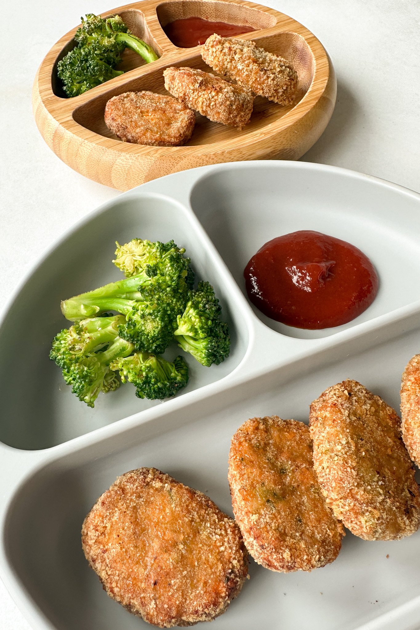 Veggie chicken nuggets served with broccoli and ketchup.