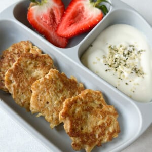 Cinnamon apple fritters served with strawberries and yogurt.