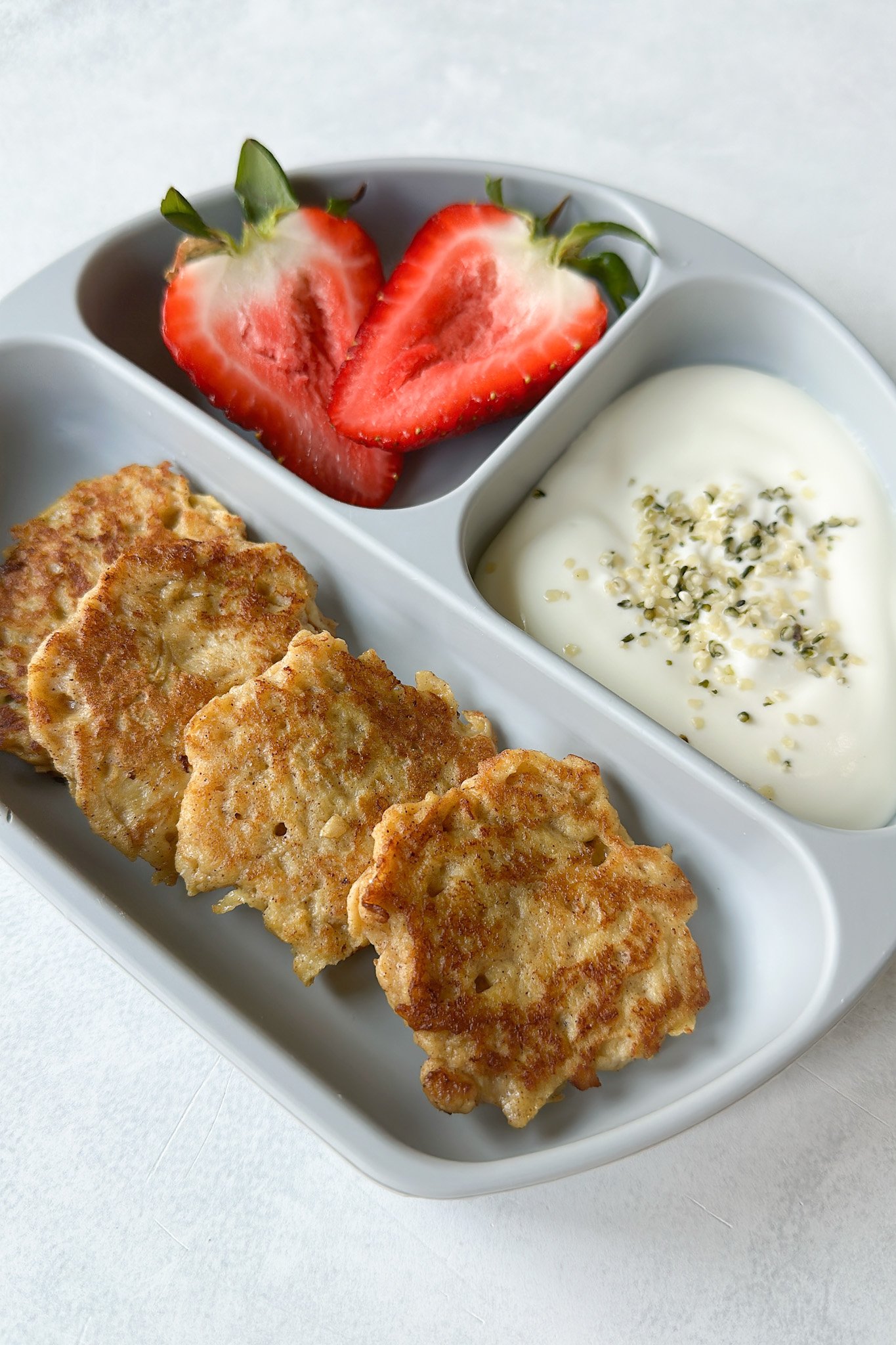 Cinnamon apple fritters served with strawberries and yogurt.