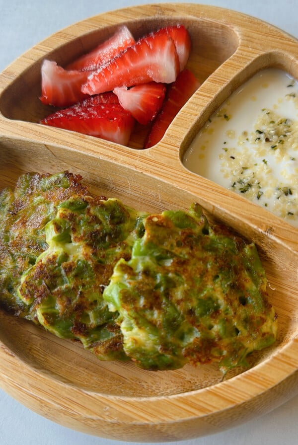 Green bean fritters served with strawberries and yogurt dip.