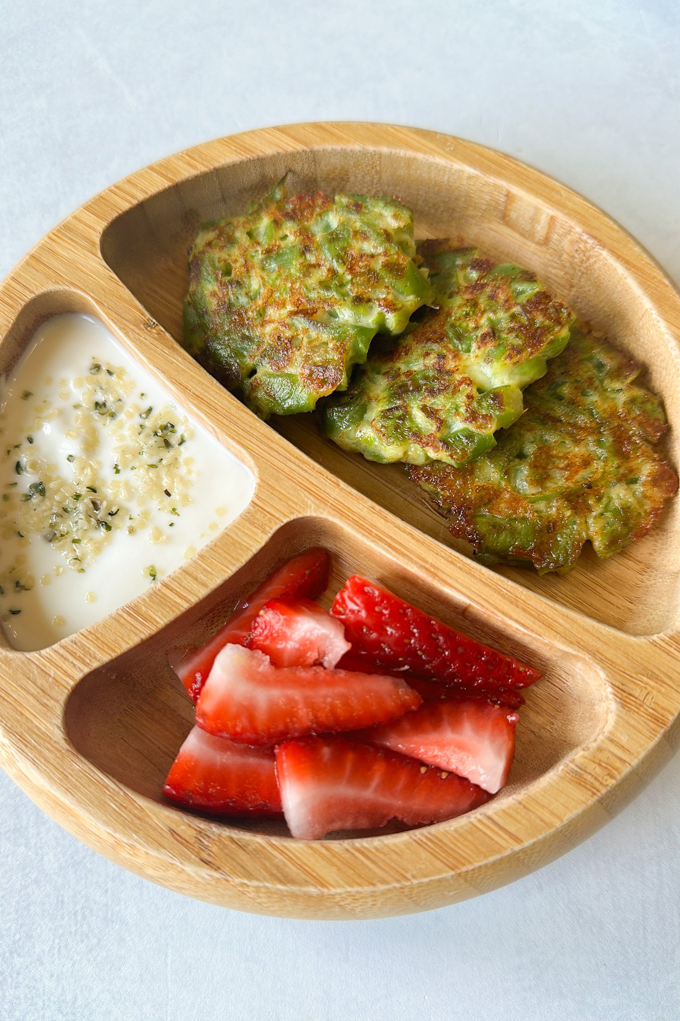 Green bean fritters served with yogurt dip and strawberries.