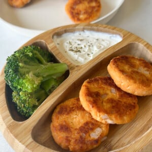 Sweet potato salmon cakes served with broccoli and yogurt dip.