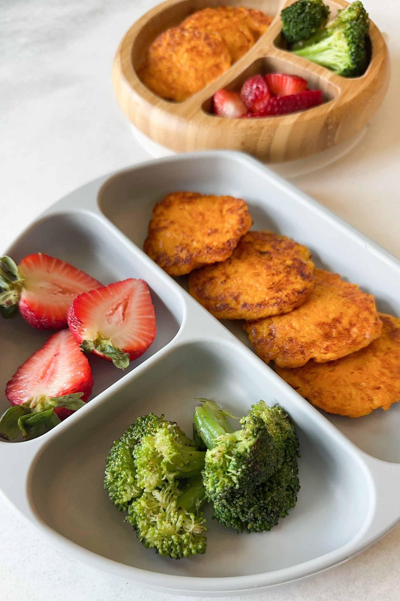 Cheesy carrot fritters served with strawberries and broccoli.