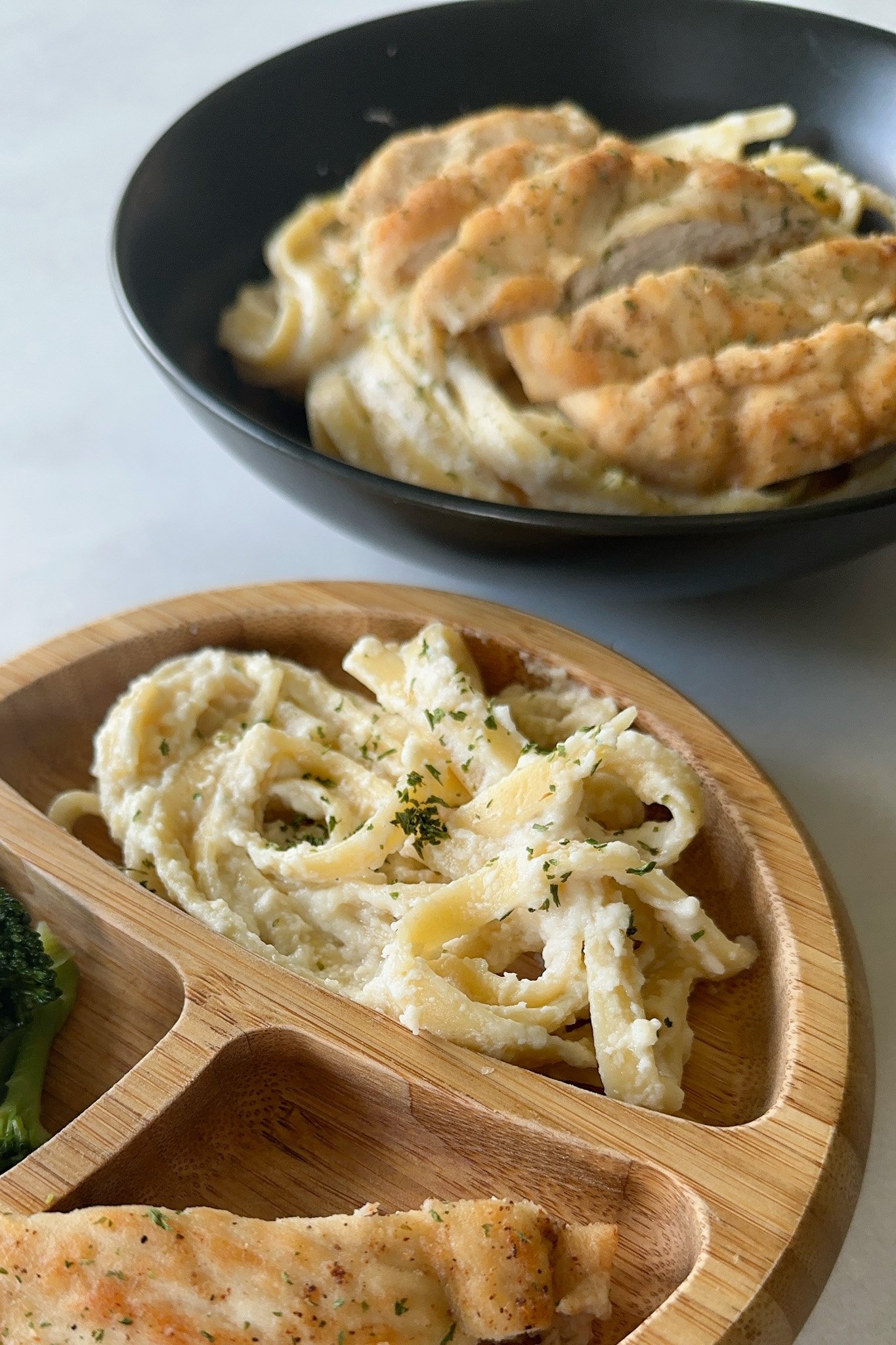 Creamy cauliflower pasta baby and adult plates.