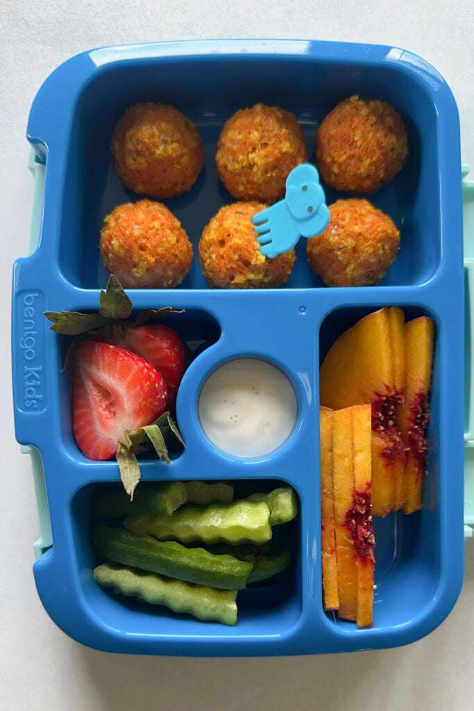 Cheesy carrot bites served with cucumbers, ranch dip, strawberries, and peaches.