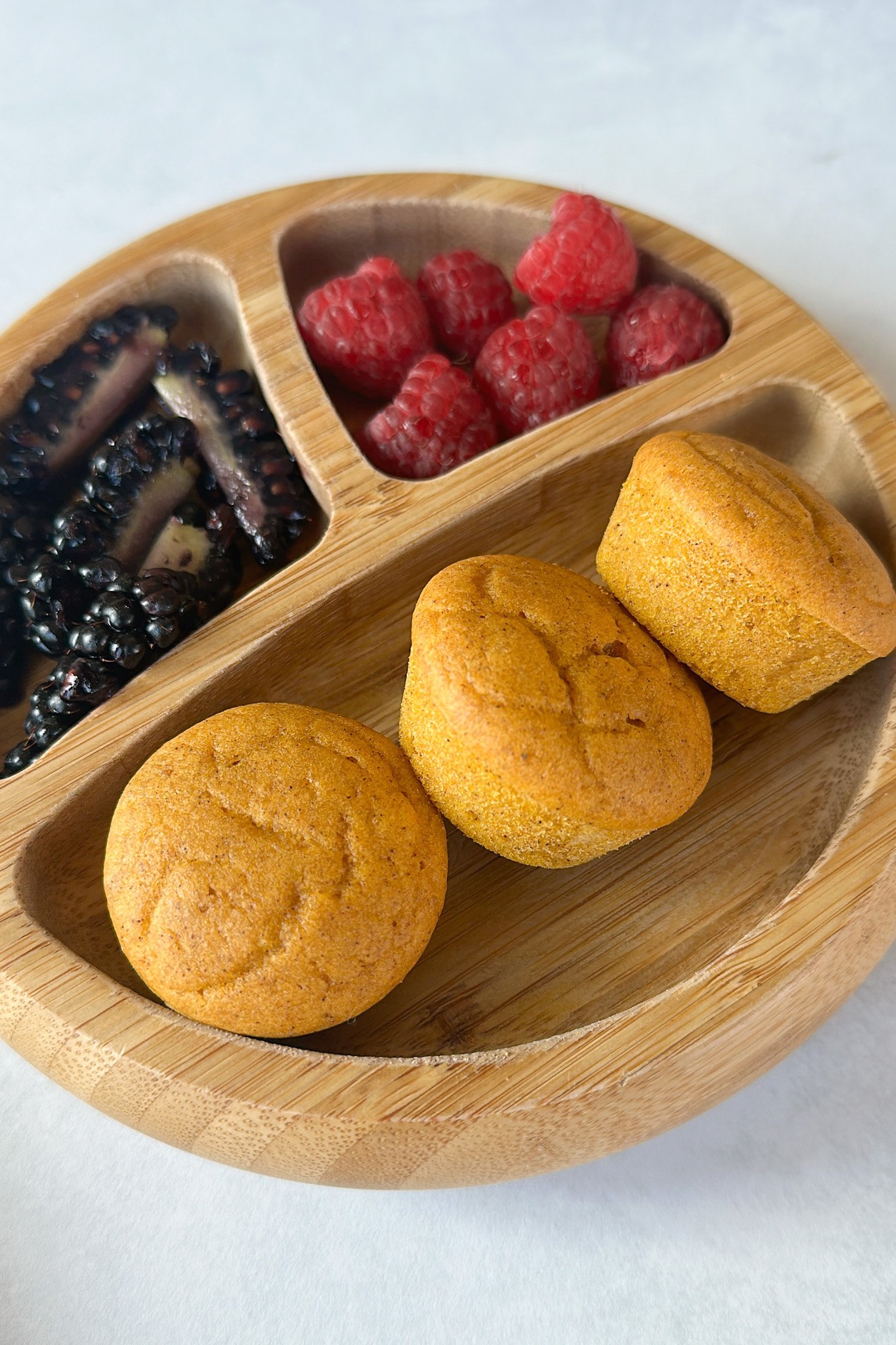 Pumpkin maple muffins served with berries.