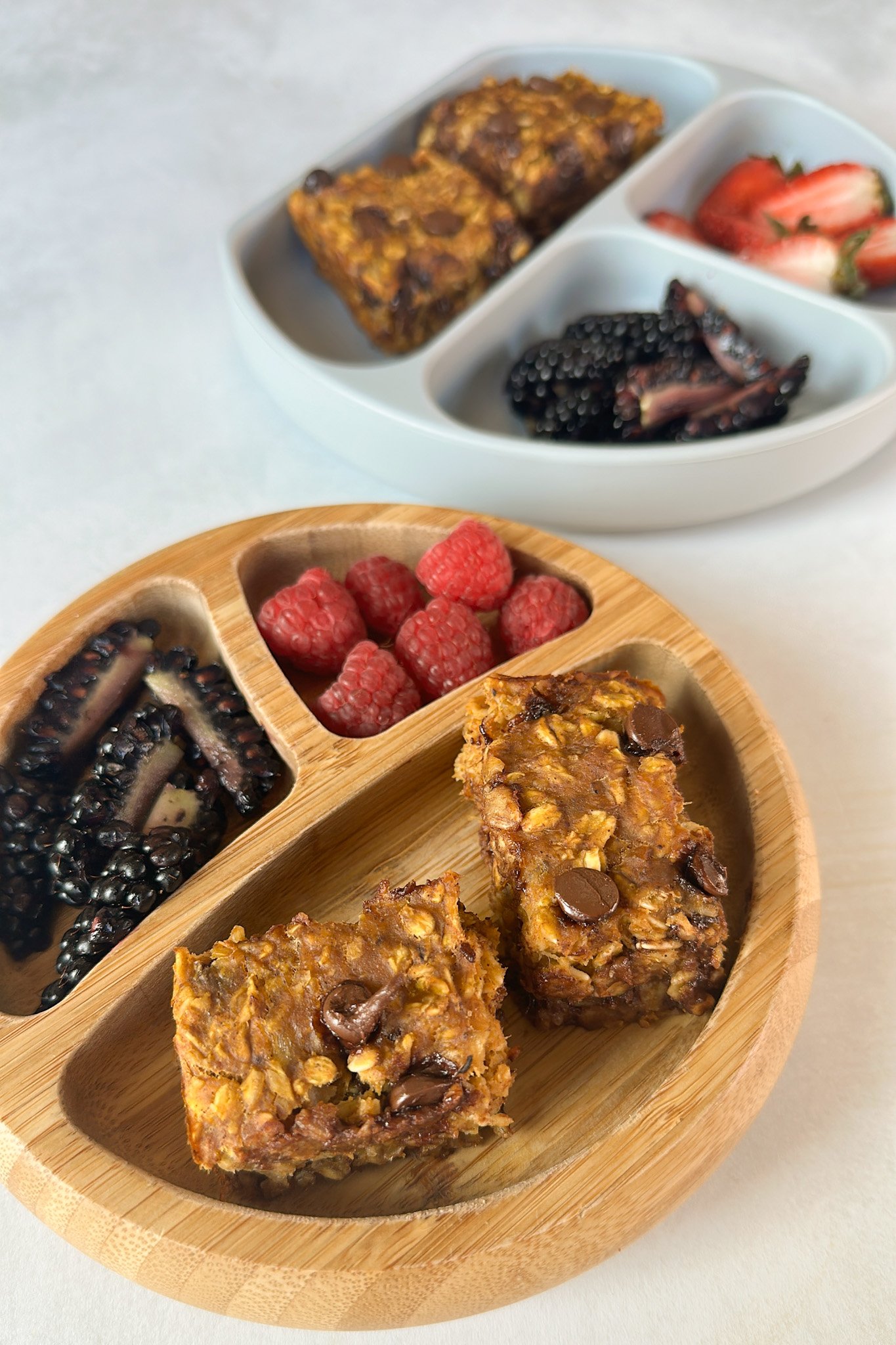 Pumpkin banana oatmeal bars served with berries.