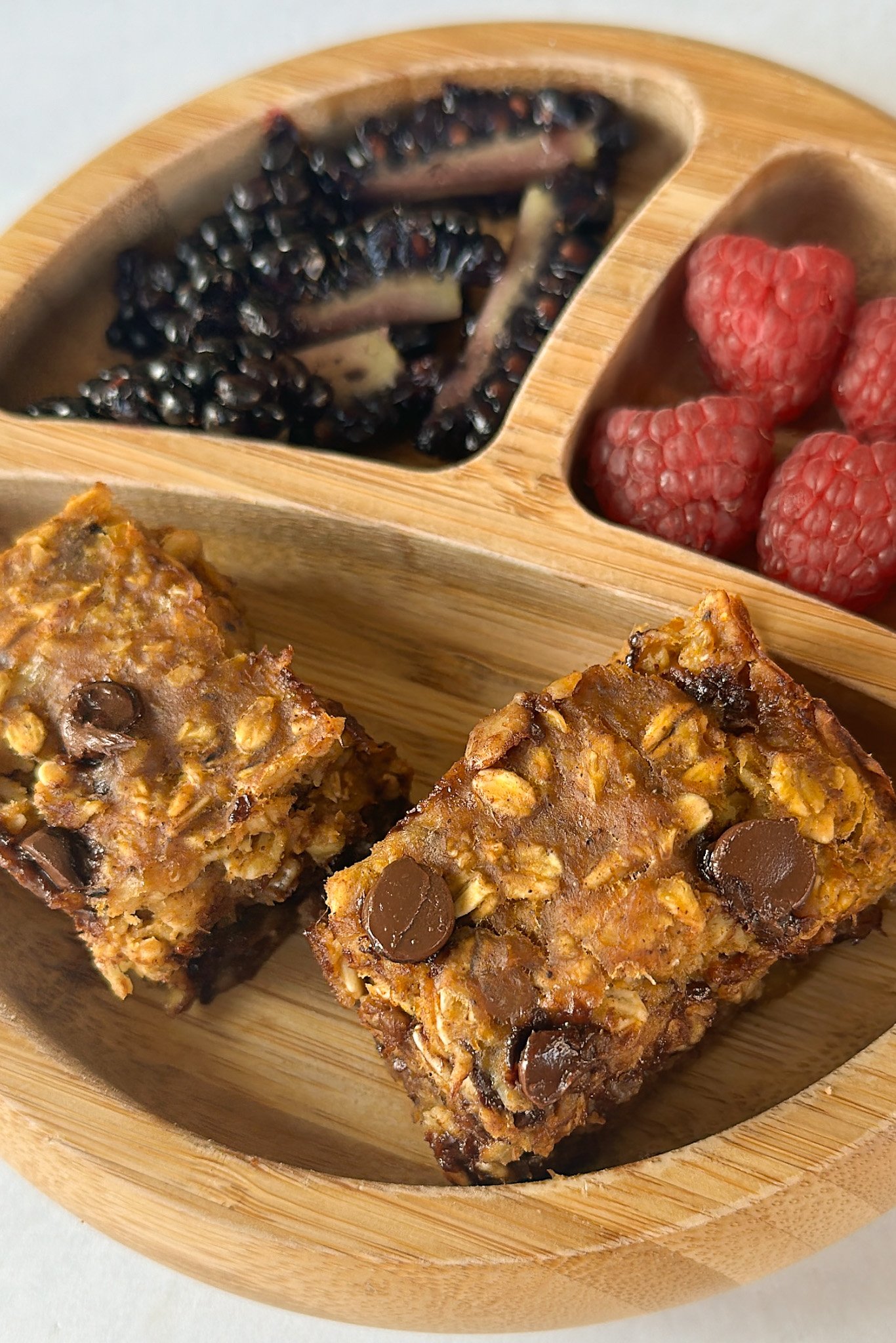 Pumpkin banana oatmeal bars served with berries.