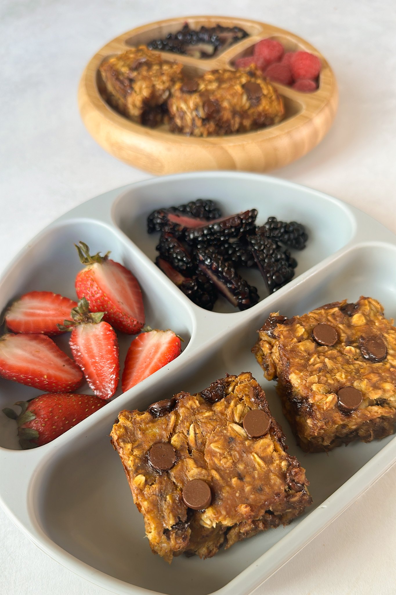 Pumpkin banana oatmeal bars served with berries.