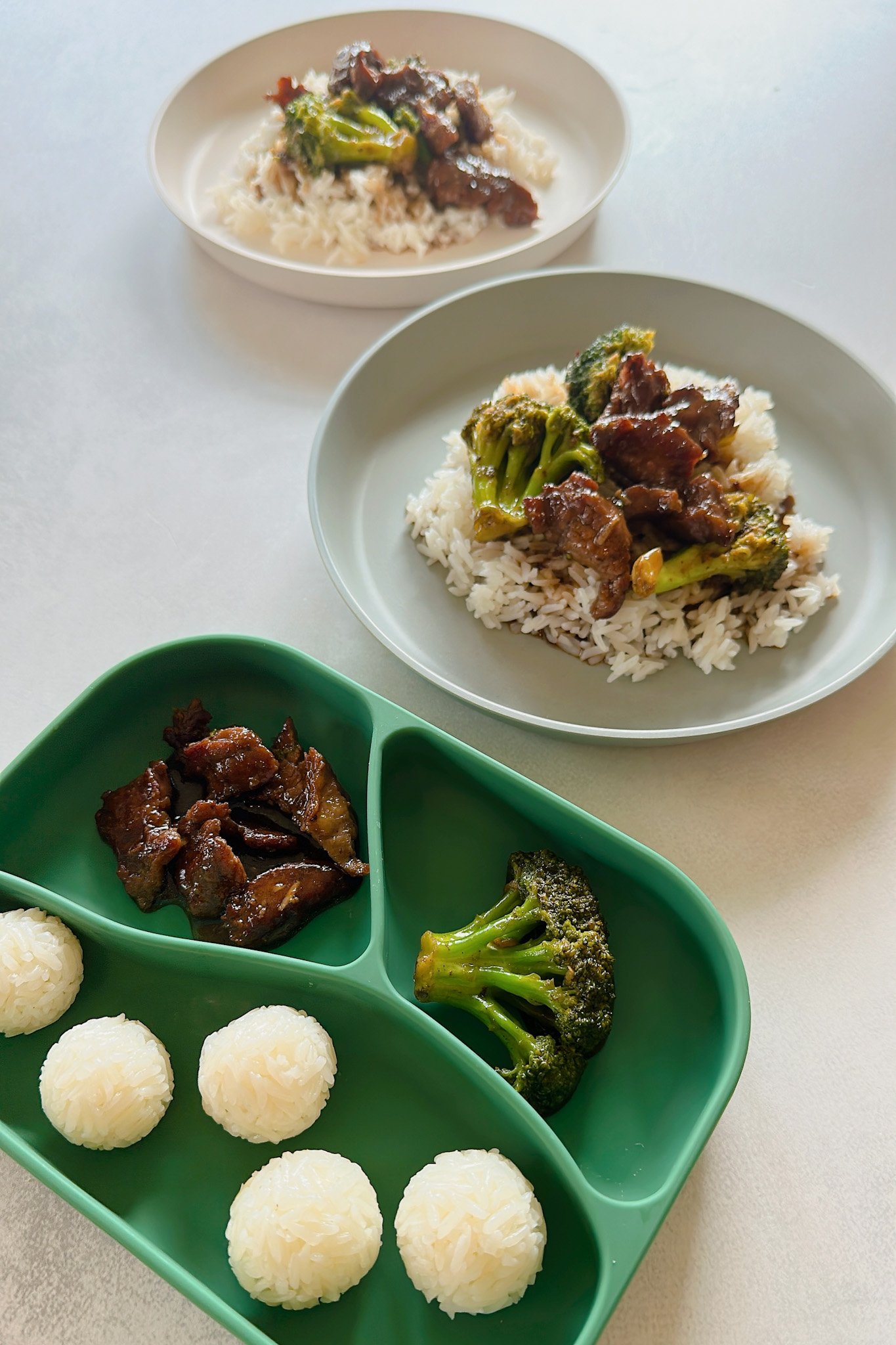 Beef and broccoli stir fry servings for a baby and two toddlers.