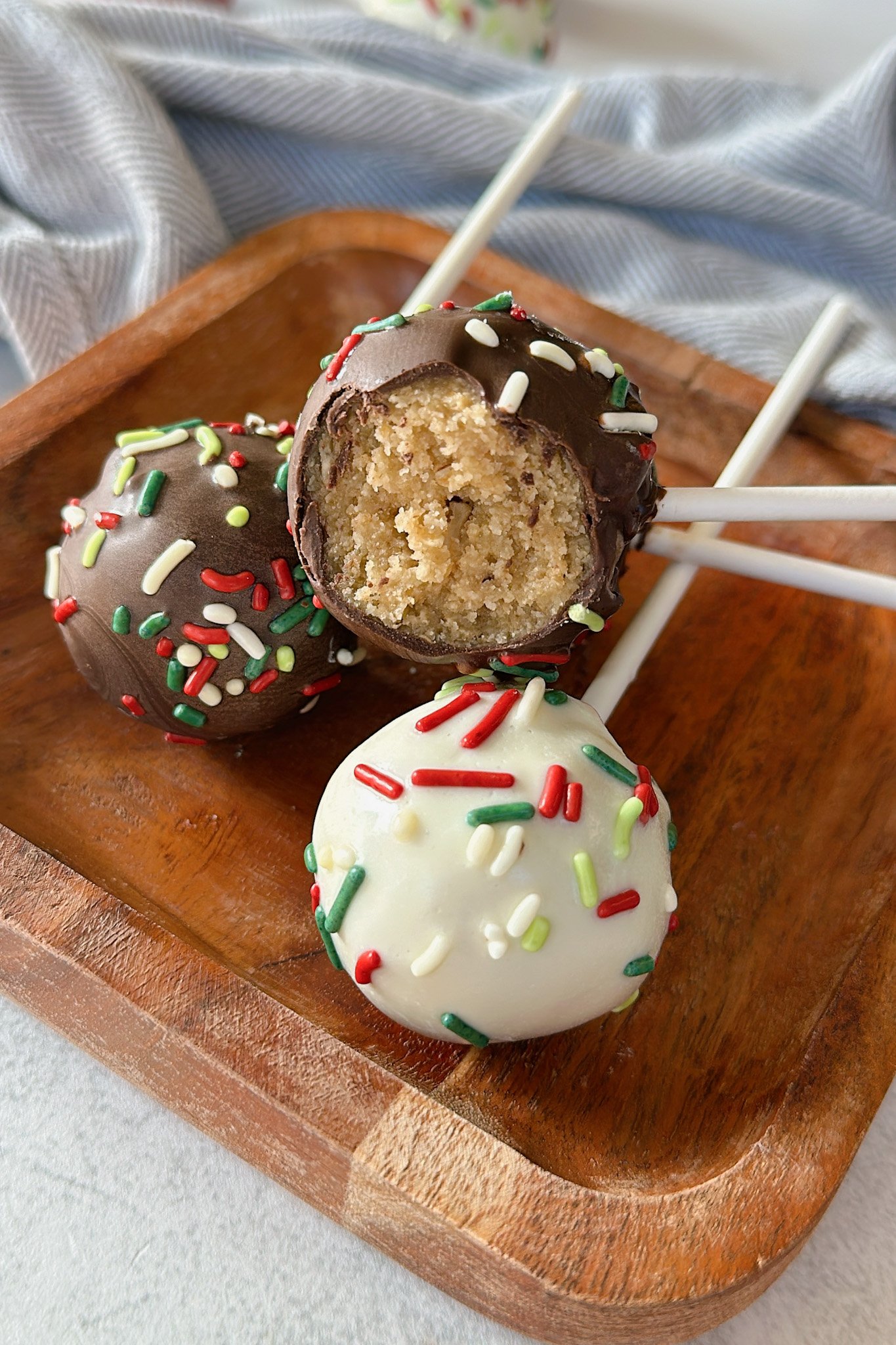 Christmas cake bites on a wooden plate.