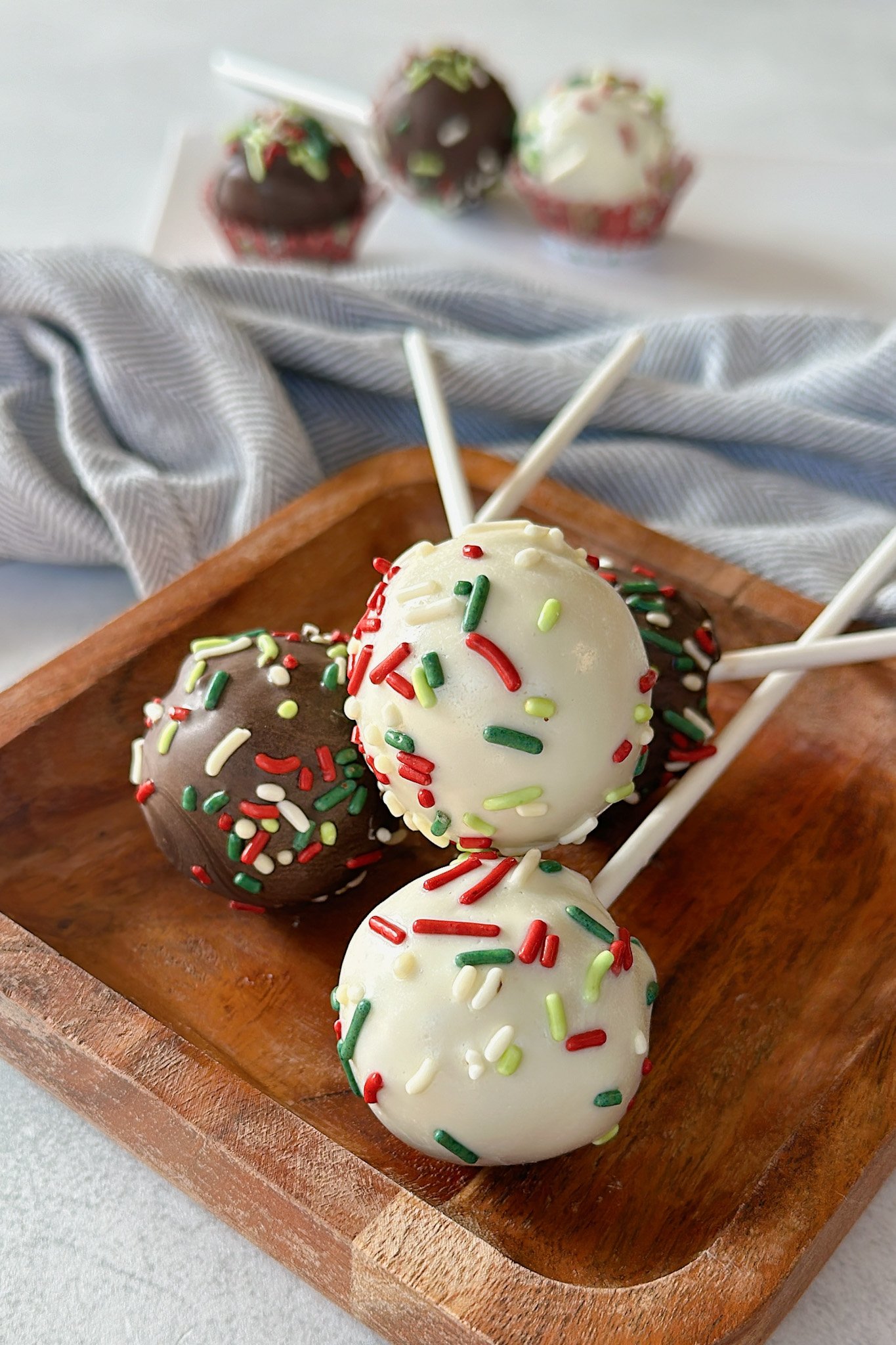 Christmas cake bites on a wooden plate.