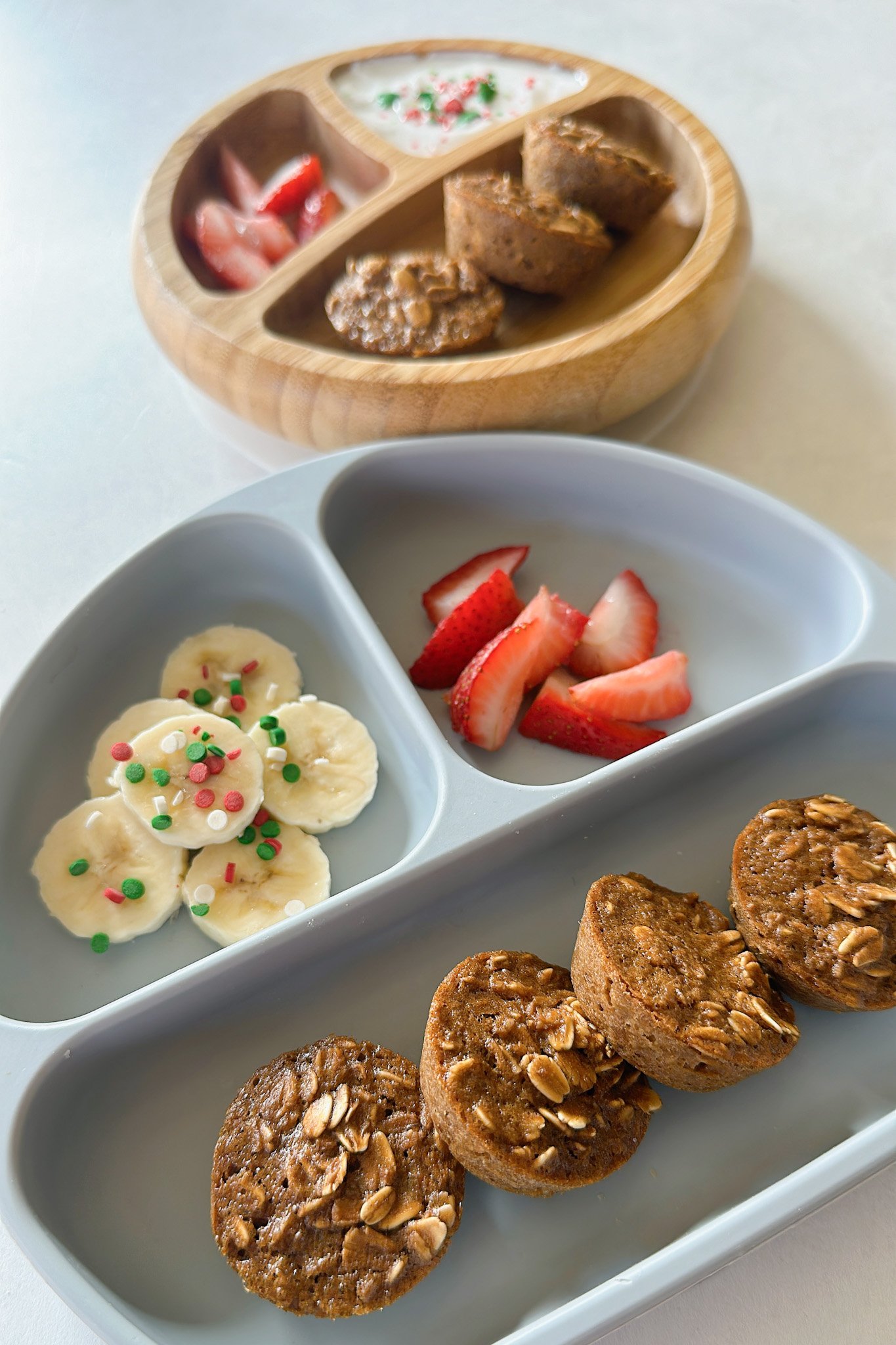 Gingerbread baked oatmeal bites served with strawberries, yogurt, and bananas.