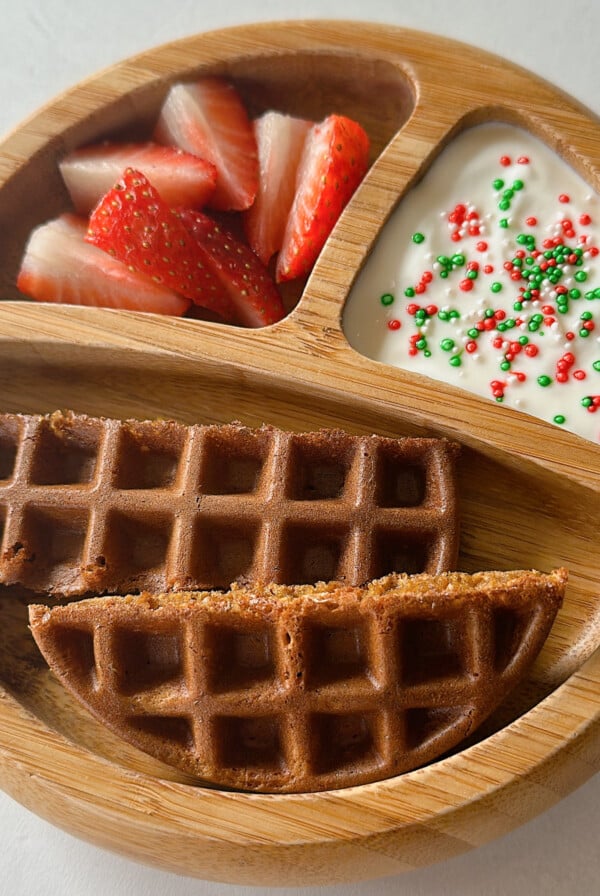 Gingerbread waffles served with yogurt and strawberries.