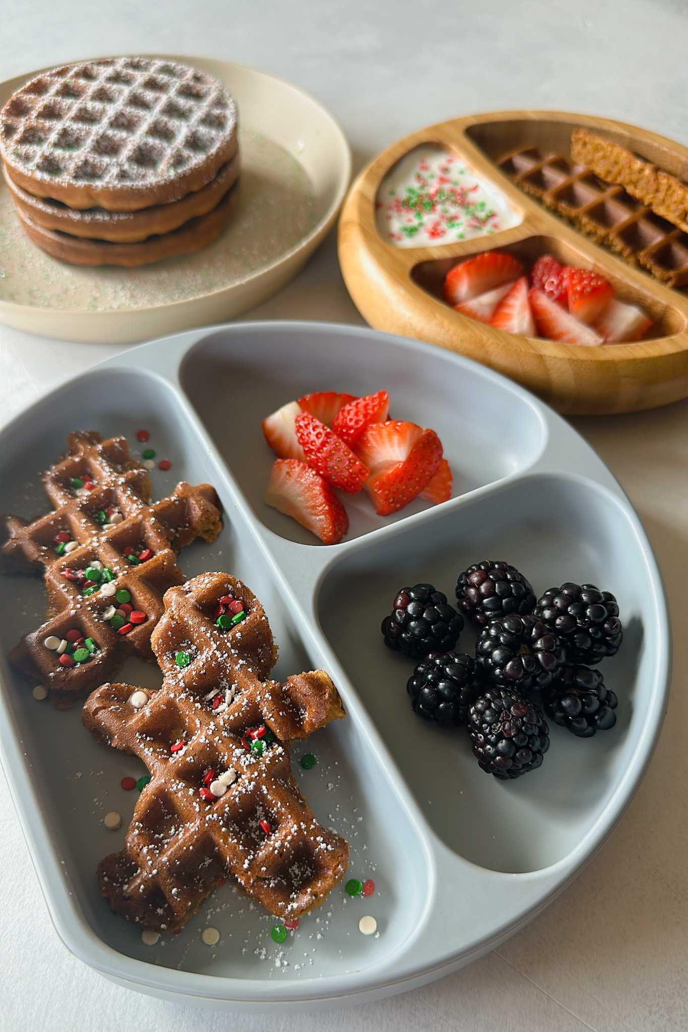 Gingerbread waffles served with yogurt, strawberries and blackberries.