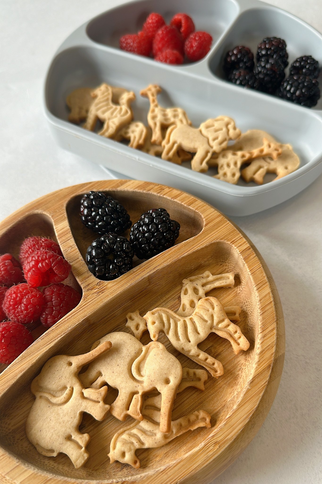 Animal crackers served with blackberries and raspberries.