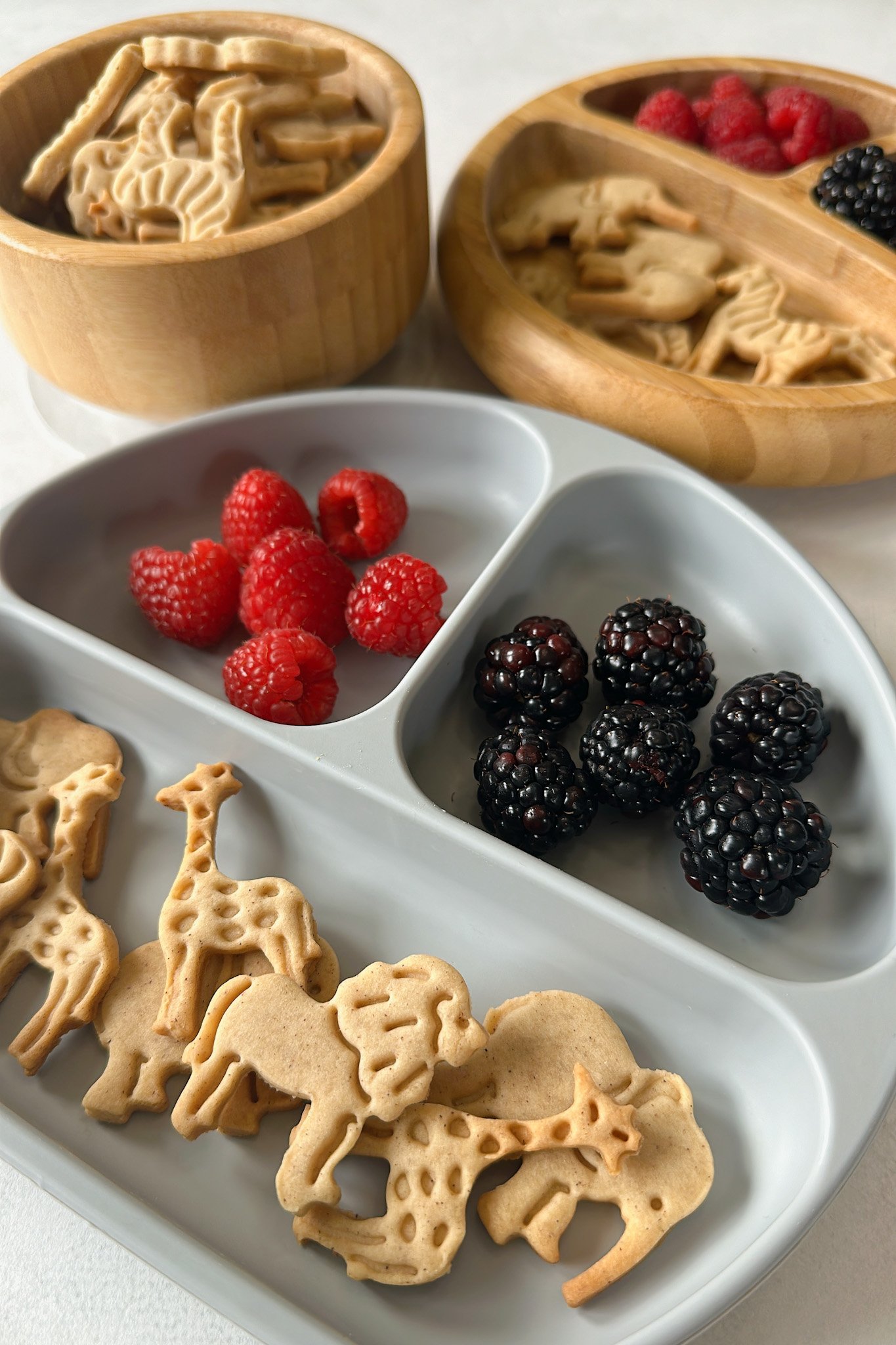 Animal crackers served with blackberries and raspberries.