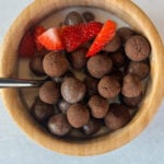 Cocoa puffs cereal served with strawberries.