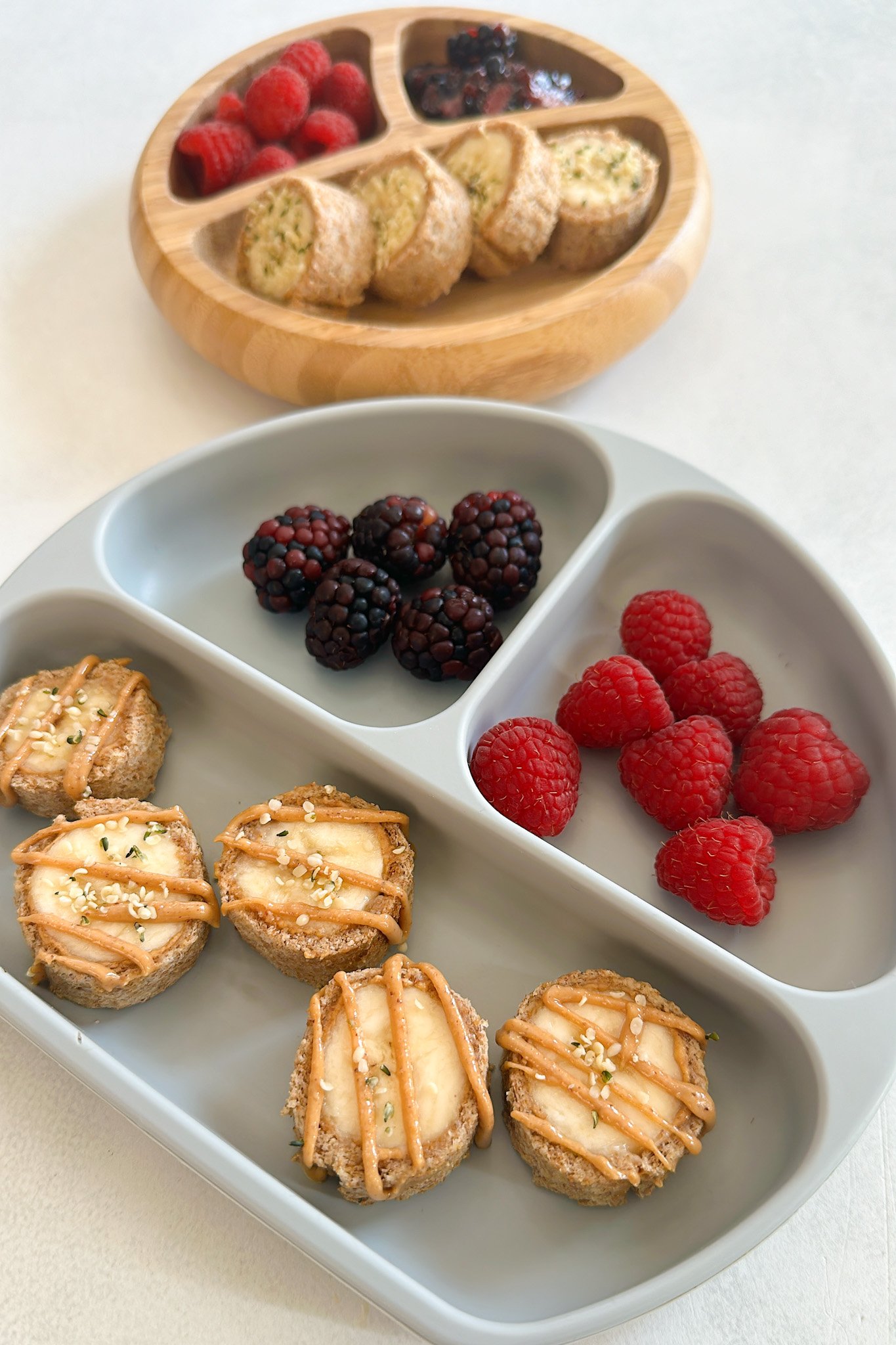 Banana sushi rolls served with berries.