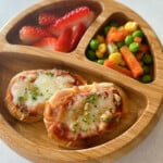 Air fryer naan pizzas served with strawberries and mixed vegetables.