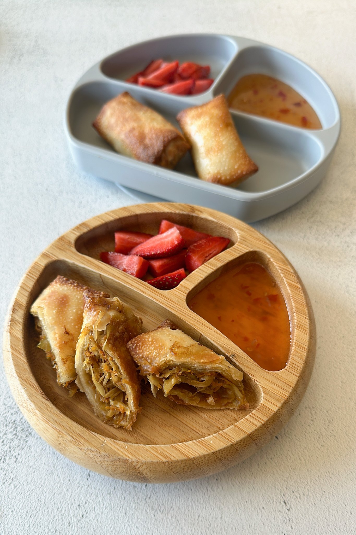Air fried egg rolls served with sweet chili sauce and strawberries.