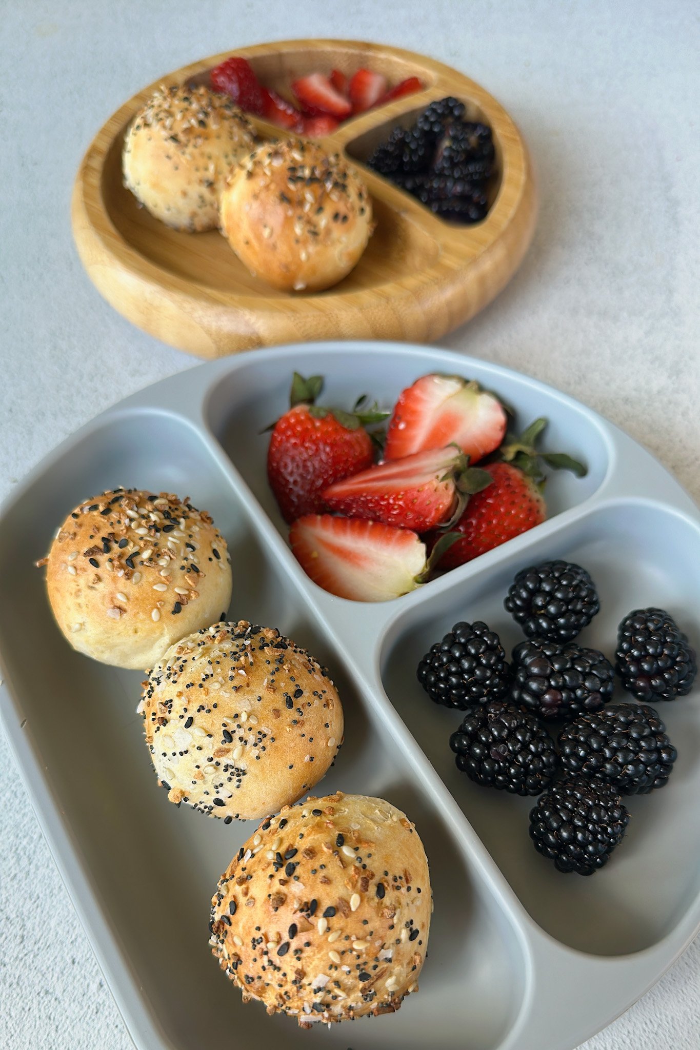 Everything bagel bites served with berries.