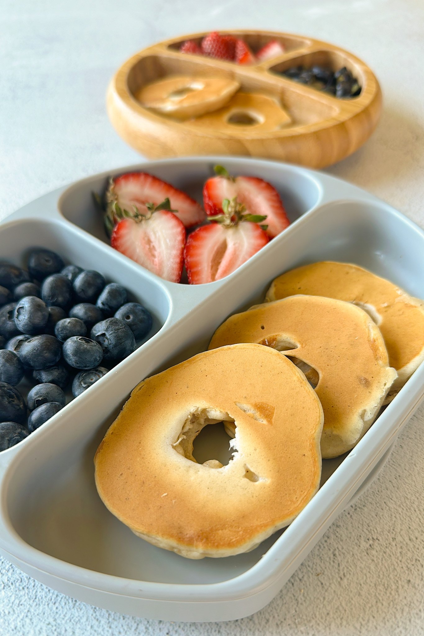 Dipped pear pancakes served with strawberries and blueberries.