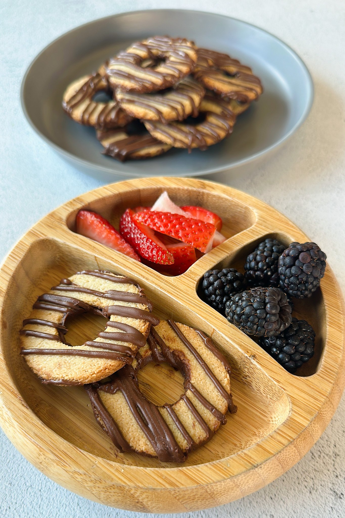 Fudge stripe cookies served with berries.